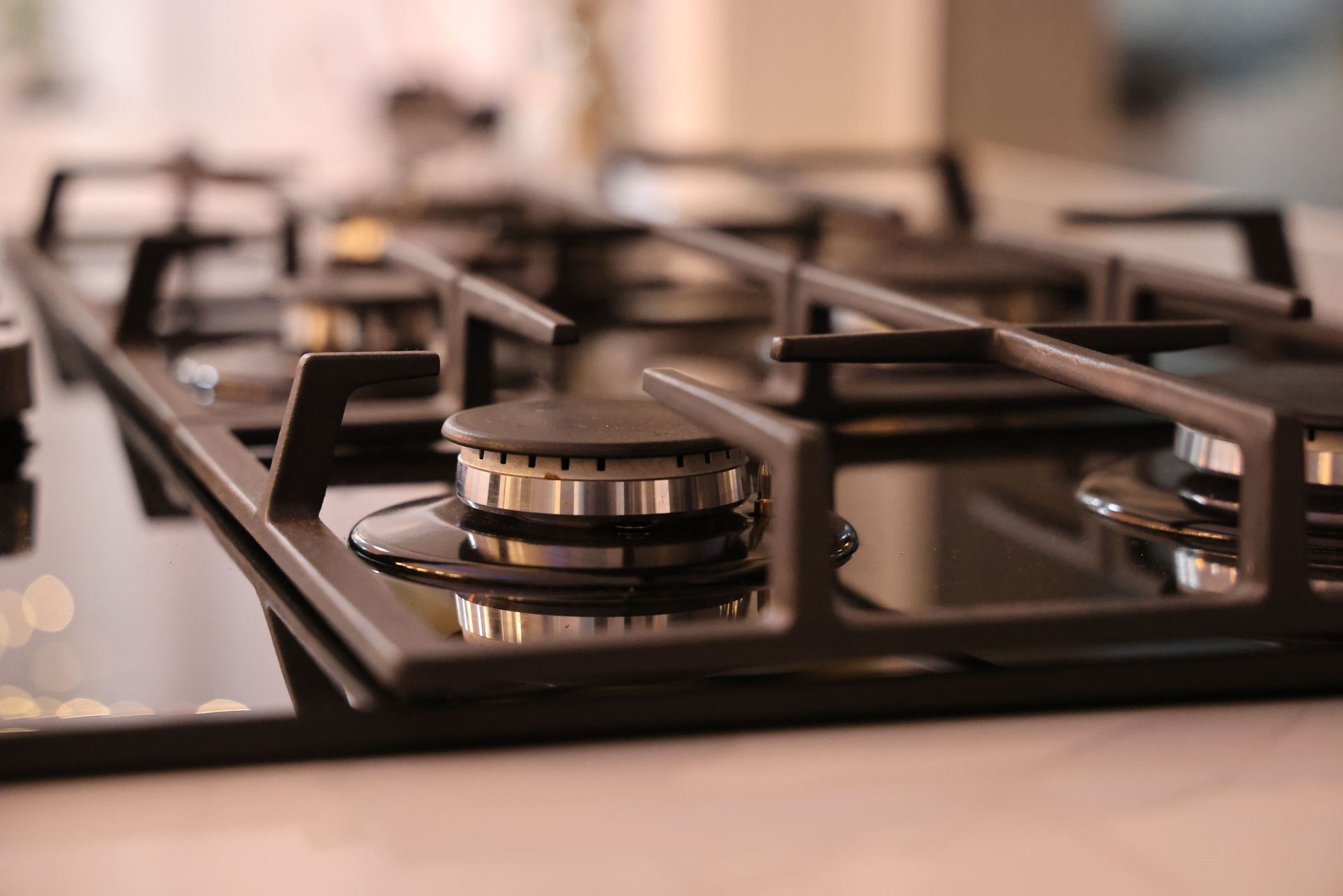Close-up of a modern stainless steel gas stove top, ideal for contemporary kitchens and cooking environments.