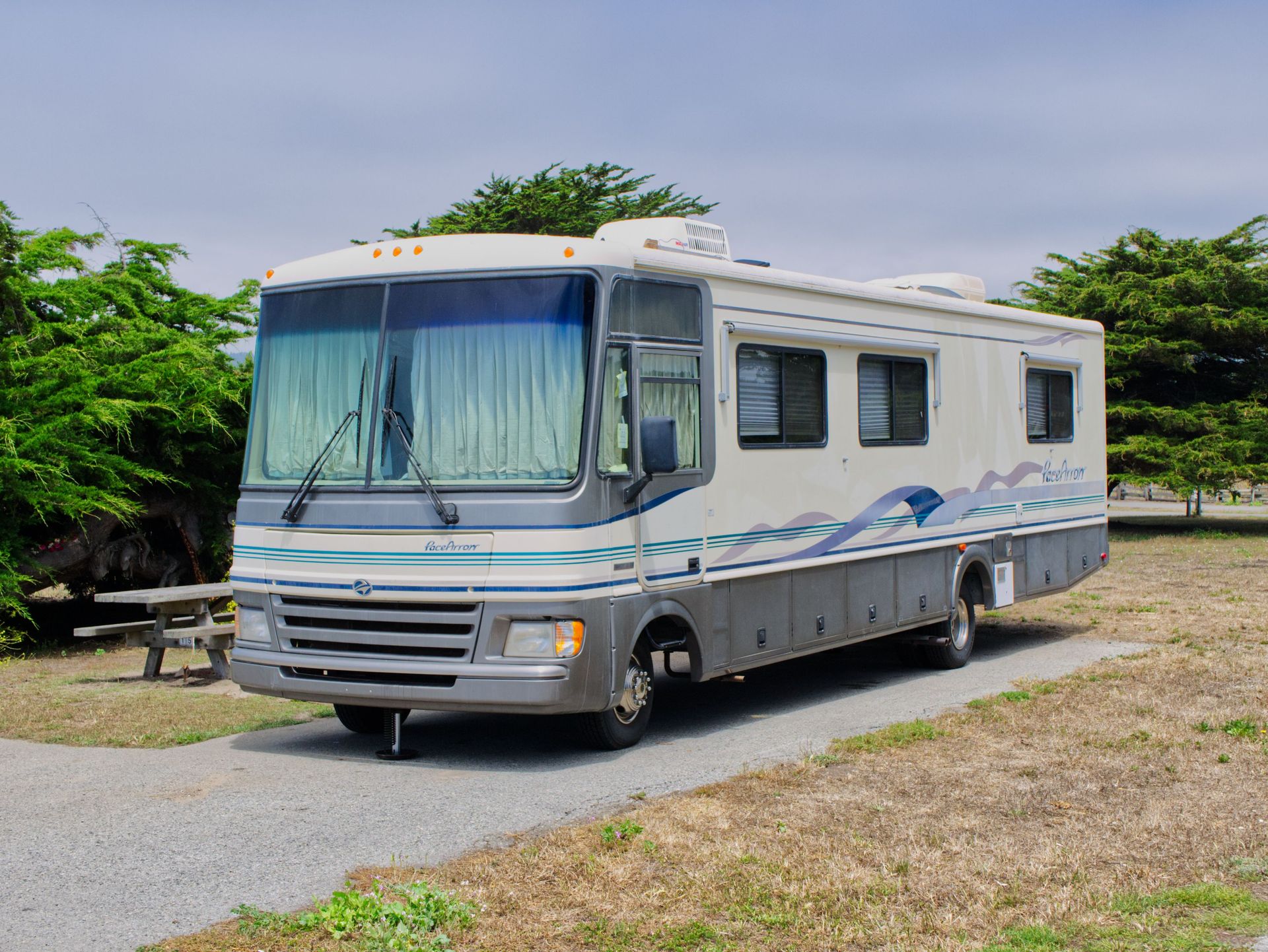 Explore the scenic campsite with a comfortable RV parked at Half Moon Bay.